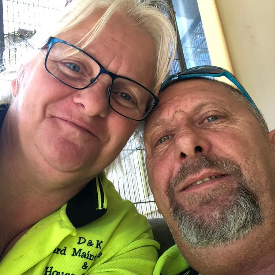 The husband and wife behind D and K, together in their work shirts.